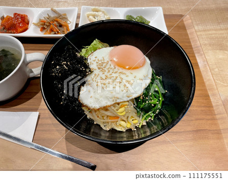 Bibimbap (Korean food) served on a tray on the table 111175551
