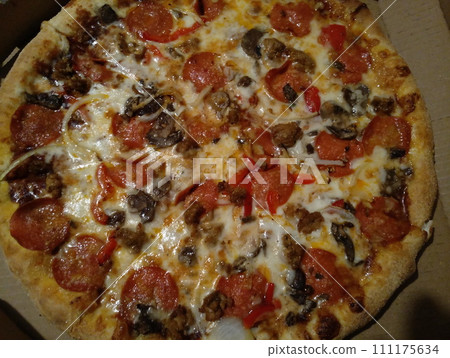 homemade pizza on the kitchen table homemade pizza on the kitchen table 111175634