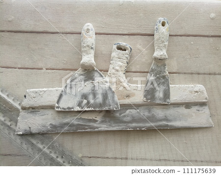 spatula for painters on a wooden chair spatula for painters on a wooden chair 111175639