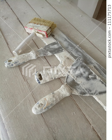 spatula for painters on a wooden chair spatula for painters on a wooden chair 111175713