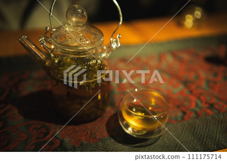 Chinese tea pot and stylish teacup on the mat Chinese tea pot and stylish teacup on the mat 111175714