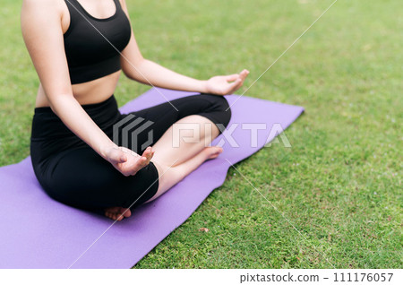Serene Yoga Journey. Balanced on a lotus pose, a woman practices yoga amidst the tranquil greenery of the jungle, embracing nature's serenity. Serene Yoga Journey. Balanced on a lotus pose, a woman practices yoga amidst the tranquil greenery of the jungle, embracing nature's serenity. 111176057