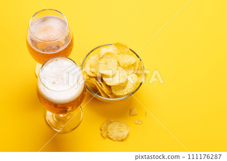 A tempting snack of beer and chips 111176287