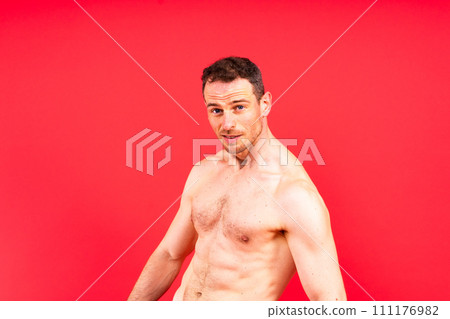 Handsome bodybuldier man posing showing muscle, shirtless torso showing pectorals and sixpack Handsome bodybuldier man posing showing muscle, shirtless torso showing pectorals and sixpack 111176982