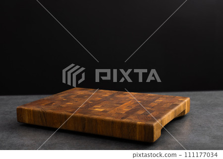 Wooden board for cutting on a black background. Wooden board for cutting on a black background. 111177034