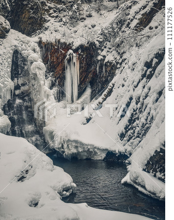 Huk waterfall, frozen waterfall at winter, Carpathian National Park. Ukraine. Huk waterfall, frozen waterfall at winter, Carpathian National Park. Ukraine. 111177526