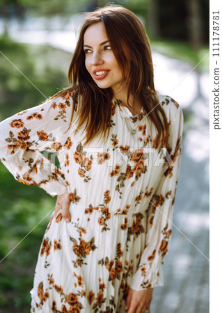 Beautiful young woman near the blooming spring tree. Attractive girl enjoying her time outside in park. Beautiful young woman near the blooming spring tree. Attractive girl enjoying her time outside in park. 111178781