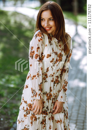 Beautiful young woman near the blooming spring tree. Attractive girl enjoying her time outside in park. Beautiful young woman near the blooming spring tree. Attractive girl enjoying her time outside in park. 111178782