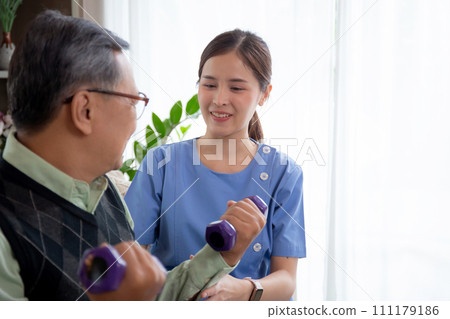 Asian caregiver woman or nurse training senior man lifting dumbbell for arm exercise. Asian caregiver woman or nurse training senior man lifting dumbbell for arm exercise. 111179186