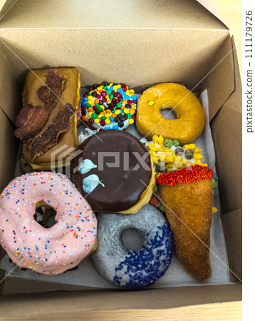 Multi-colored donuts in a box from the Voodoo Donut retail store in Portland. 111179726