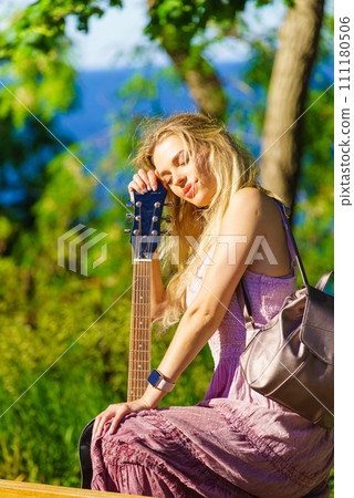 Girl with guitar outdoor on nature Girl with guitar outdoor on nature 111180506