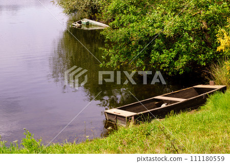 Boat on lake shore 111180559
