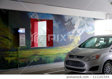 DETROIT, MICHIGAN, UNITED STATES - 22 MAY 2018: Silver car parked in a public car park with graffiti on the wall DETROIT, MICHIGAN, UNITED STATES - 22 MAY 2018: Silver car parked in a public car park with graffiti on the wall 111181503