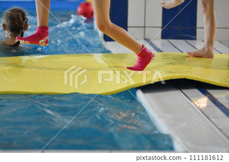 Child in neoprene socks with anti-slipping sole Child in neoprene socks with anti-slipping sole 111181612