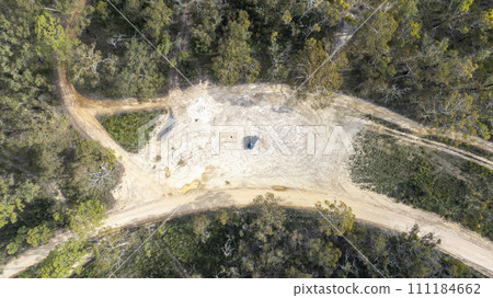 Aerial photograph looking down on an offroad vehicle parked on a dirt track in regional Australia Aerial photograph looking down on an offroad vehicle parked on a dirt track in regional Australia 111184662