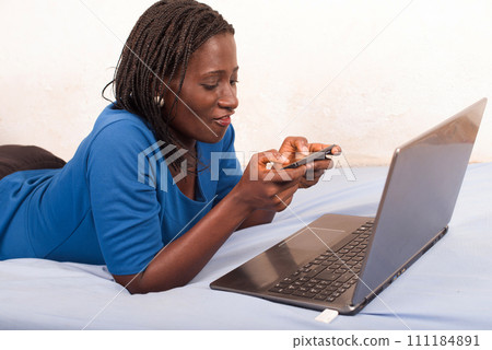 Beautiful young woman using mobile phone plays games 111184891