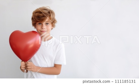 Boy holding a heart-shaped balloon on a white background isolated on white 111185131
