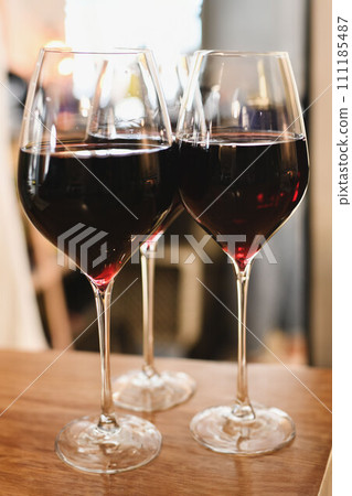 The glasses with red French wine in a restaurant The glasses with red French wine in a restaurant 111185487