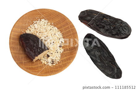 Tonka bean isolated on white background with full depth of field. Bean of Dipteryx odorata, Top view. Flat lay Tonka bean isolated on white background with full depth of field. Bean of Dipteryx odorata, Top view. Flat lay 111185512