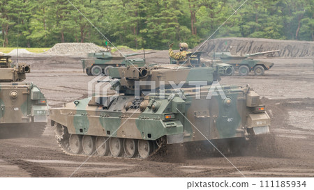 A column of Japan Ground Self-Defense Force Type 89 armored fighting vehicles running 111185934