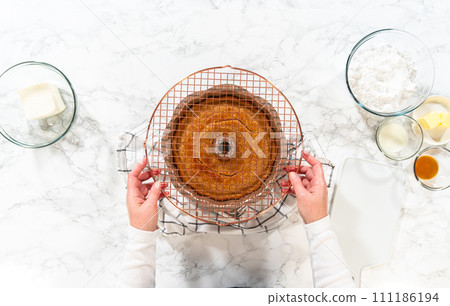 The freshly baked Carrot Bundt Cake is left to cool on the kitchen counter, filling the air with delightful aromas. 111186194