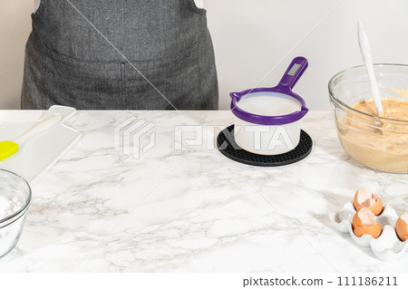 The vegetable shortening is expertly melted for greasing the bundt cake pan, setting the stage for baking this delicious cake. The vegetable shortening is expertly melted for greasing the bundt cake pan, setting the stage for baking this delicious cake. 111186211