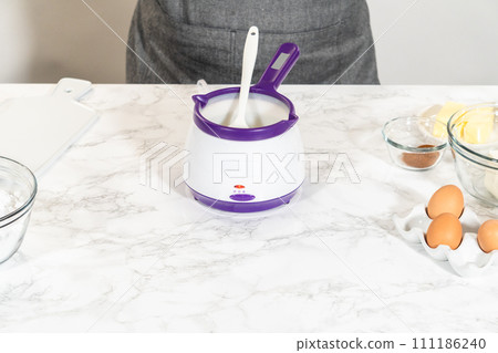 The vegetable shortening is expertly melted for greasing the bundt cake pan, setting the stage for baking this delicious cake. The vegetable shortening is expertly melted for greasing the bundt cake pan, setting the stage for baking this delicious cake. 111186240