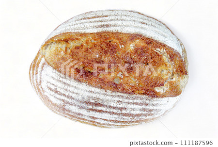Homemade delicious bread with wheat flour on a crust on a white background, flat lay. Healthy handmade sourdough bread, home baking concept Homemade delicious bread with wheat flour on a crust on a white background, flat lay. Healthy handmade sourdough bread, home baking concept 111187596