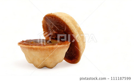 Halves of fresh and tasty cookies in the shape of a walnut with boiled condensed milk on a white background. A favorite delicacy for children and adults with a delicate filling inside 111187599