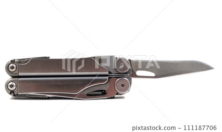 A steel multi-tool with an open knife blade lies on a white background. Pocket open folding knife. Portable multitasking multitool with many tools. EDC concept. A tool for daily practice. All in one 111187706