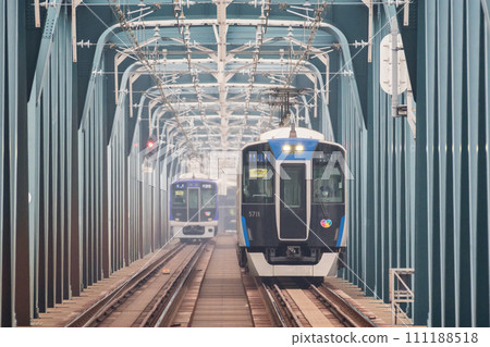 [Hanshin Main Line] Local train crossing the Yodogawa Bridge 111188518