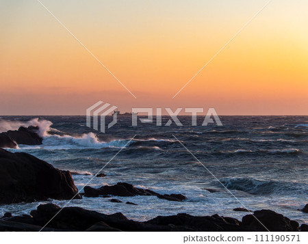 Dynamic sunset view of the Pacific Ocean seen from Nojimazaki with strong winds and rough waves 111190571