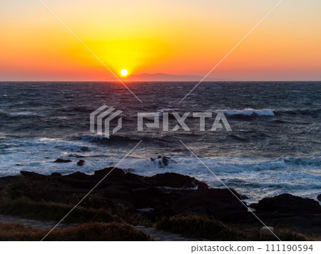 Dynamic sunset view of the Pacific Ocean seen from Nojimazaki with strong winds and rough waves 111190594