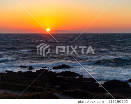 Dynamic sunset view of the Pacific Ocean seen from Nojimazaki with strong winds and rough waves 111190595