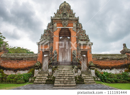 An iconic entrance gate to the inner shrine of Pura Taman Ayun the royal temple of Mengwi empire in Badung Regency, Bali, Indonesia. An iconic entrance gate to the inner shrine of Pura Taman Ayun the royal temple of Mengwi empire in Badung Regency, Bali, Indonesia. 111191444