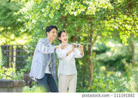couple holding a camera couple holding a camera 111191882