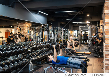 Gym muscle training young men and women 111192008