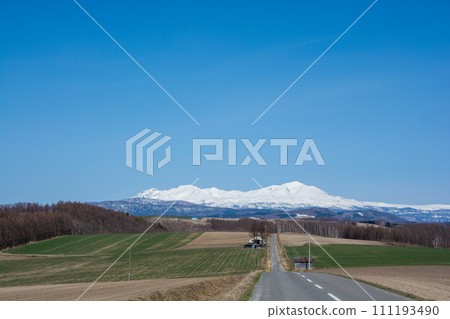 Spring hilly upland field and mountain range of remaining snow Daisetsuzan Spring hilly upland field and mountain range of remaining snow Daisetsuzan 111193490