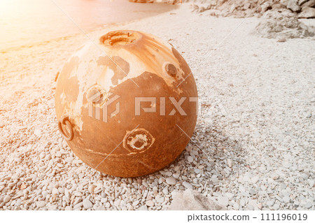 Old rusty sea mine on the beach. Old rusty sea mine on the beach. 111196019