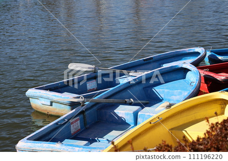 Scenery of a pond with colorful boats parked Scenery of a pond with colorful boats parked 111196220