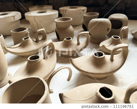 Clay blanks for a kerosene lamp in a pottery workshop. Close up photo Clay blanks for a kerosene lamp in a pottery workshop. Close up photo 111196781