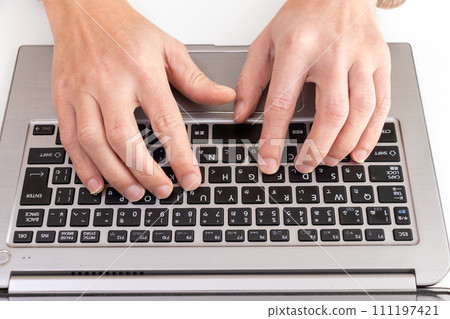 Hands of a person typing on a laptop keyboard Hands of a person typing on a laptop keyboard 111197421