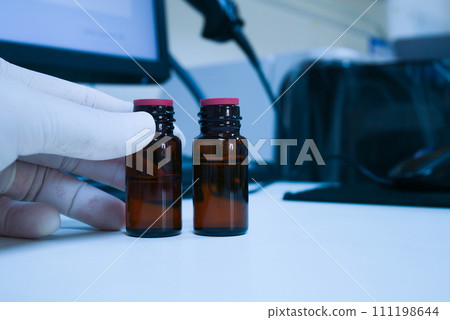 Brown bottle with reagen on white table. Brown bottle with reagen on white table. 111198644