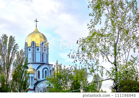 Christian cathedral with golden domes.Spring blossoming trees 111198848