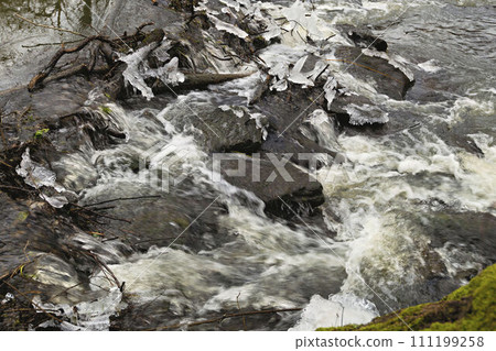 cold water flows over the stones 111199258