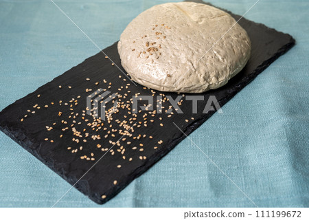Sesame halva on stone black board with blue background. Sesame halva on stone black board with blue background. 111199672