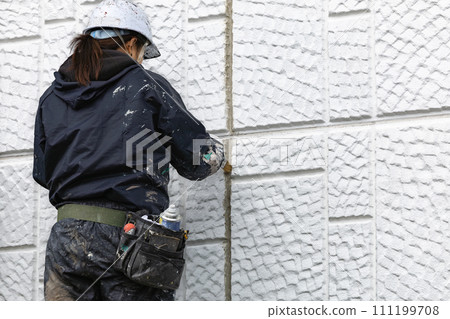 Construction site girl, exterior wall crack repair work, painting 111199708