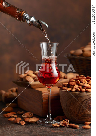 Italian liqueur Amaretto with almonds nuts. 111200084
