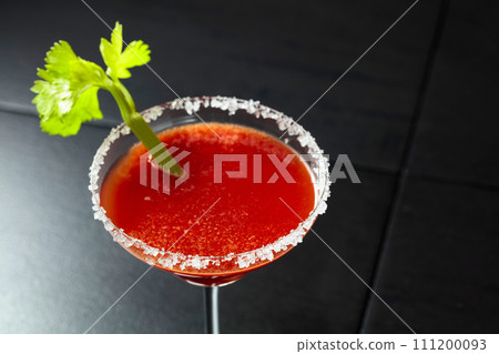 Bloody Mary cocktail with celery on a black background. Bloody Mary cocktail with celery on a black background. 111200093