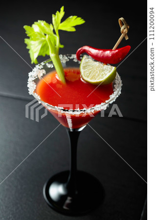 Bloody Mary cocktail with celery, lime, and red pepper. Bloody Mary cocktail with celery, lime, and red pepper. 111200094